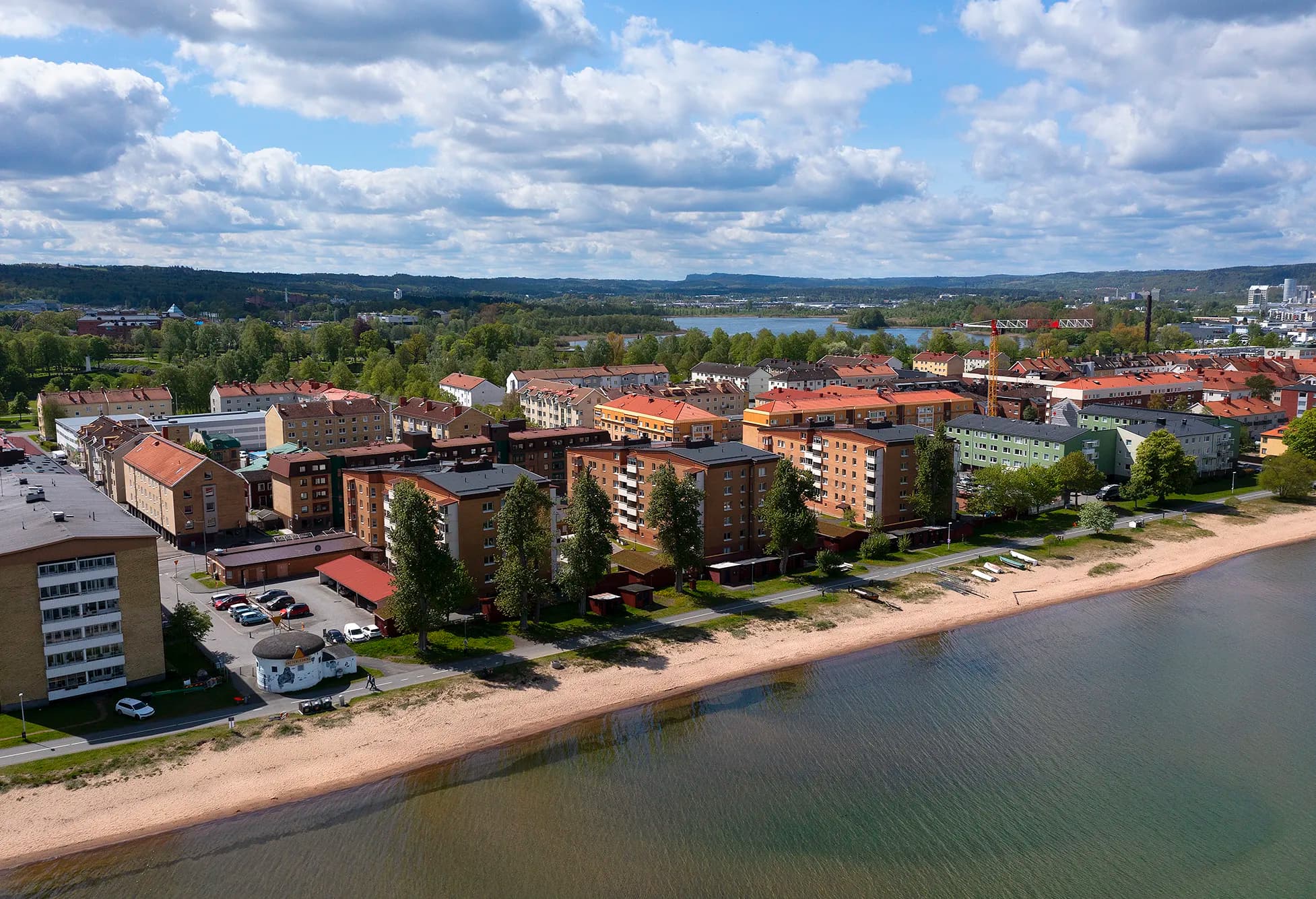 Flygfoto över flerfamiljshus längs Vätterns strand