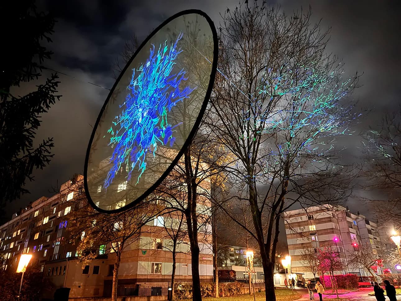 Upplyst Råslätt under ljusfestival med färgstarka ljusinstallationer mellan bostadshusen